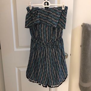 Strapless romper with elastic waist , pockets and fun navy fringe!